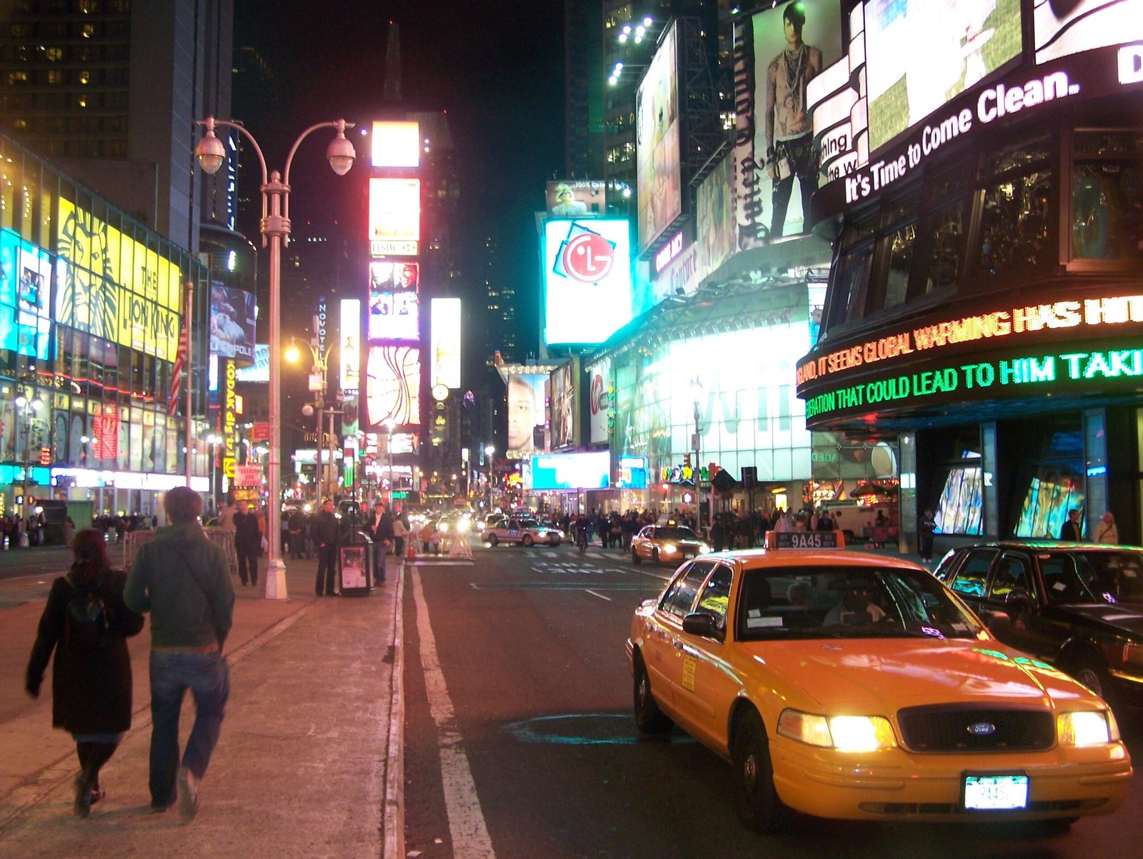 Times Square lit up with neon billboards at night in New York City